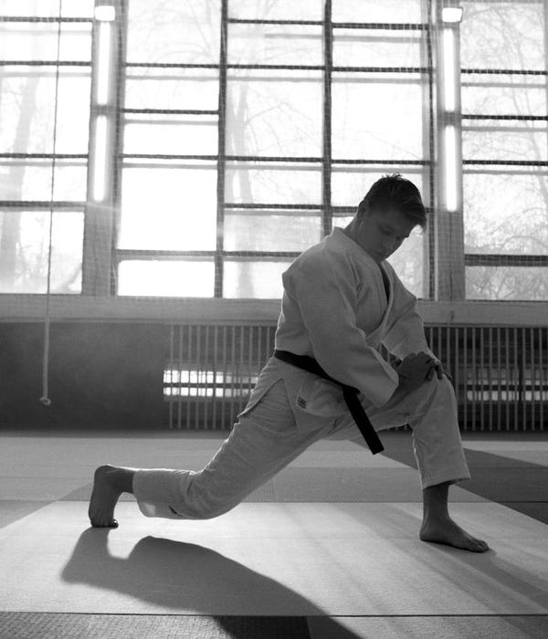 Man doing active stretching in a modern neon studio