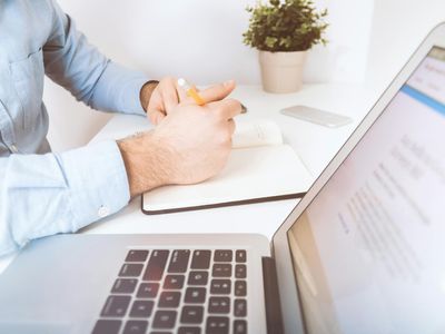 Person working at desk with laptop